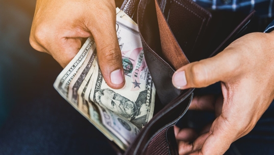 man pulling money out of wallet